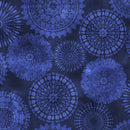 A close-up of a fabric pattern featuring large, intricate circular mandala and sunburst motifs in shades of blue on a dark navy background.