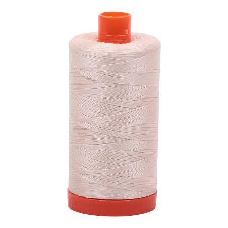 Spool of sand Aurifil Cotton Thread.