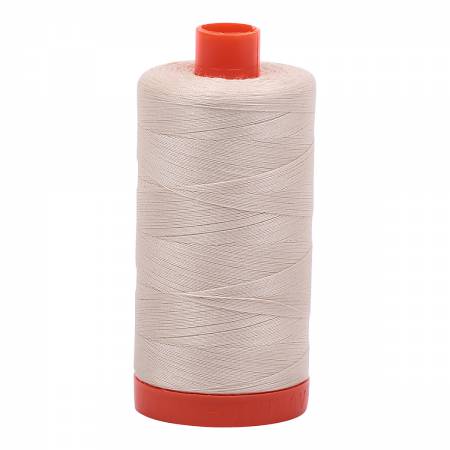 Spool of beige Aurifil Cotton Thread.