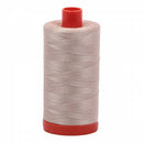 Spool of beige Aurifil Cotton Thread.