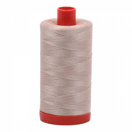 Spool of beige Aurifil Cotton Thread.