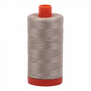 Spool of stone Aurifil Cotton Thread.