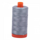 Spool of blue-grey Aurifil Cotton Thread.