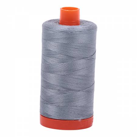 Spool of blue-grey Aurifil Cotton Thread.