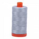 Spool of blue grey Aurifil Cotton Thread.
