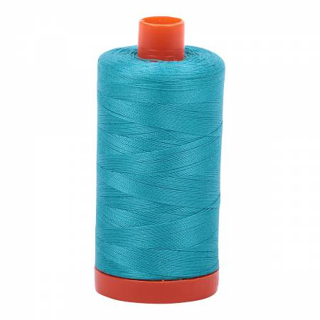 Spool of turquoise Aurifil Cotton Thread.