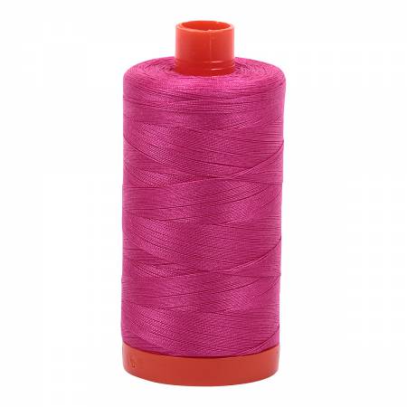 Spool of hot pink Aurifil Cotton Thread.