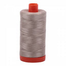 Spool of beige Aurifil Cotton Thread.