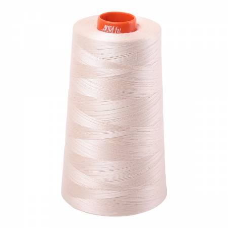 Cone of Aurifil Cotton thread that is sand coloured.